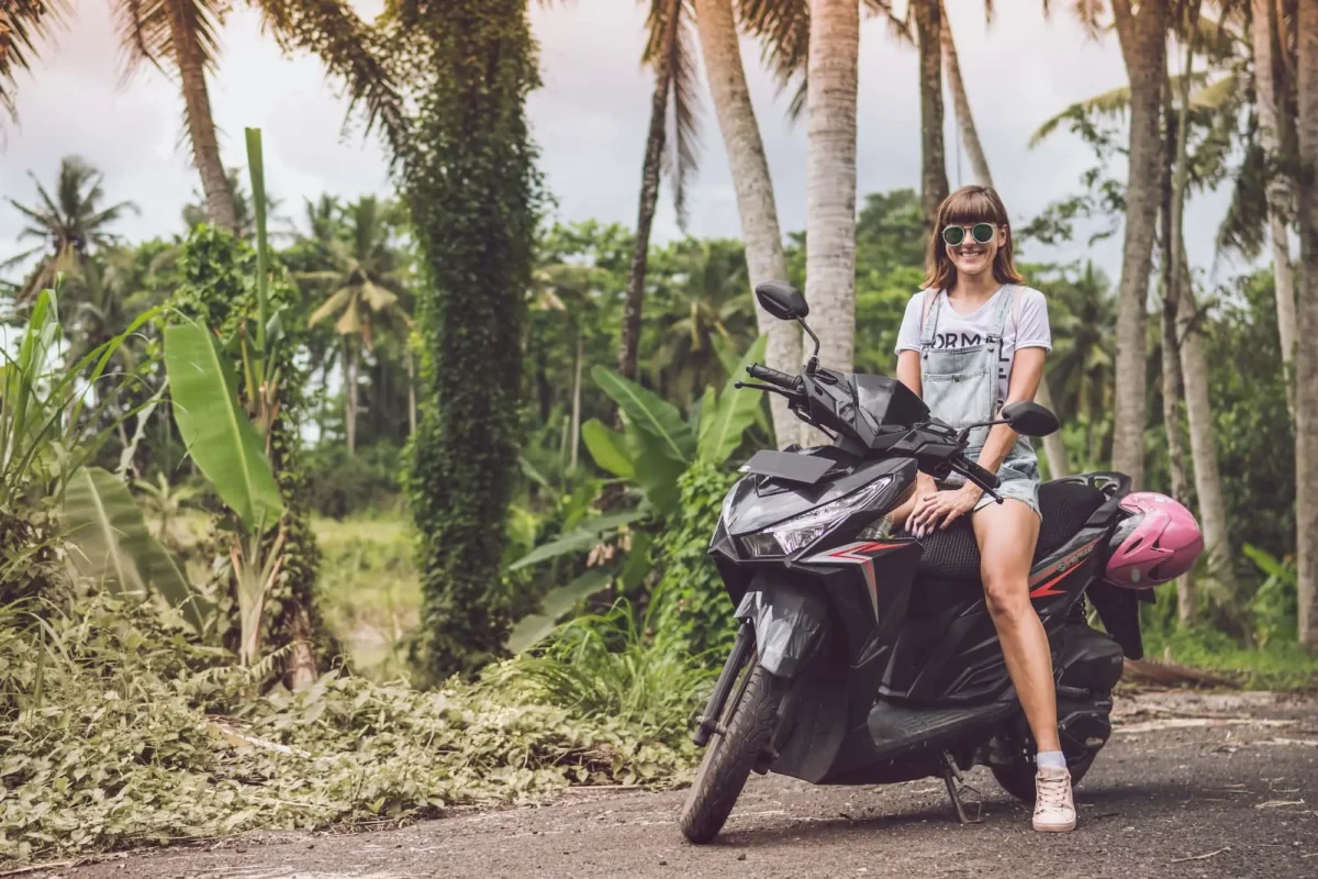 Is It Safe to Ride a Scooter in Bali? Tourist riding a scooter safely in Bali